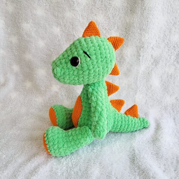 Crochet amigurumi dinosaur plushie side view