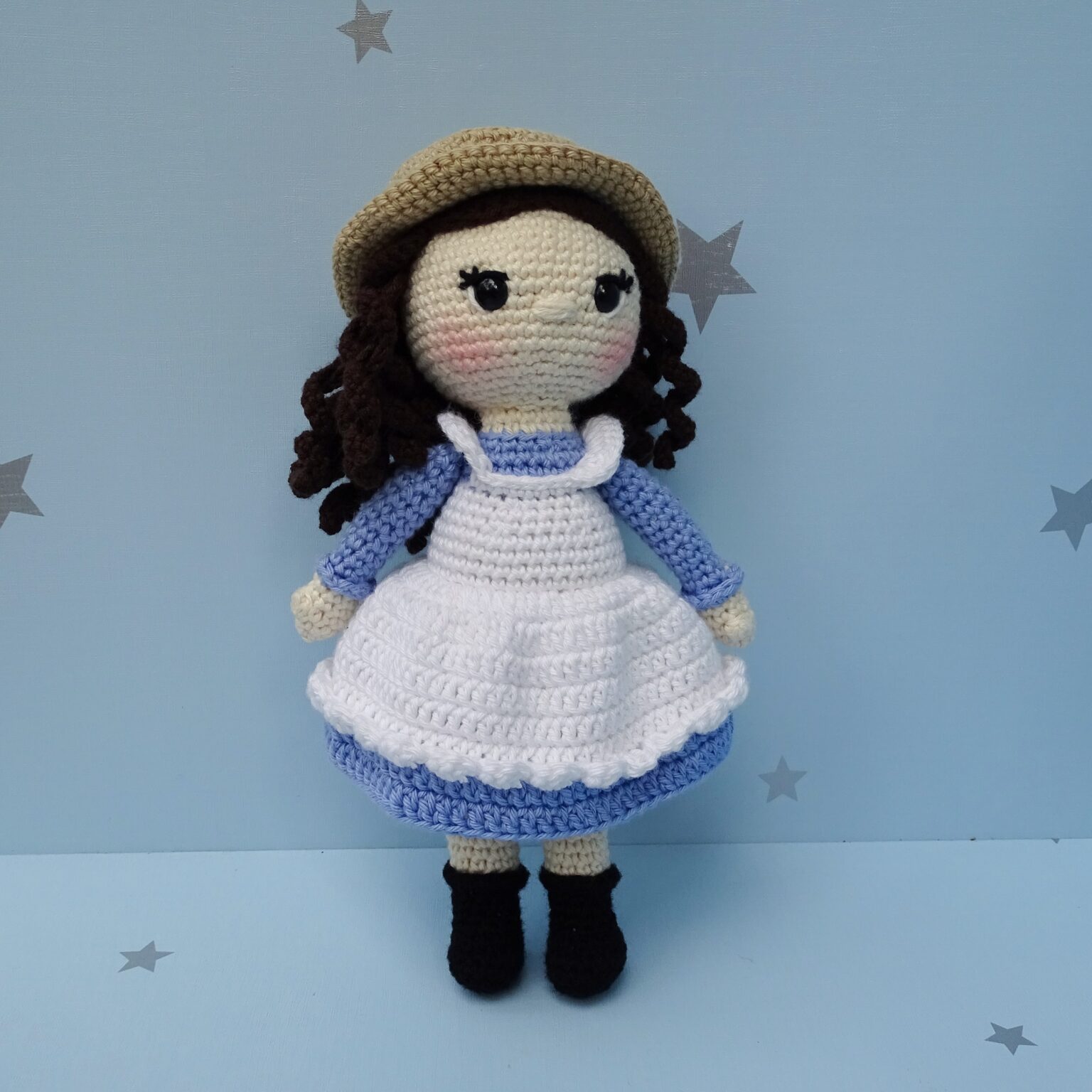 Crochet amigurumi girl doll with hat front view