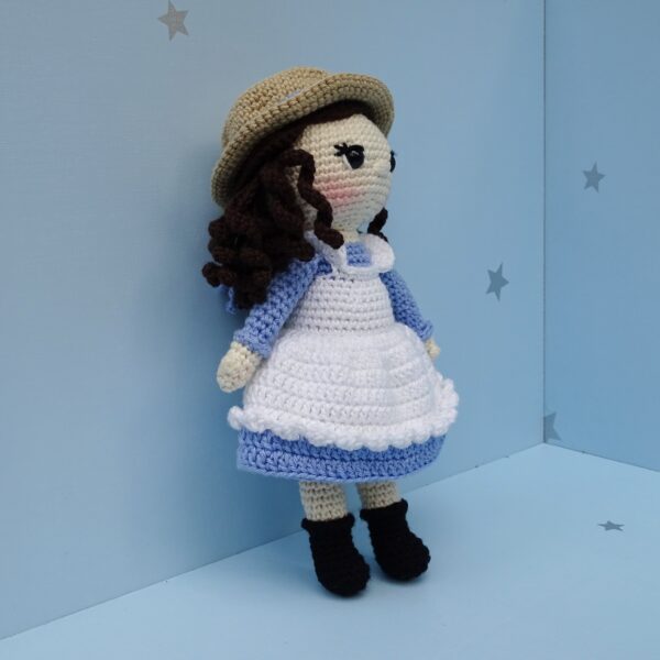 Crochet amigurumi girl doll with hat side view