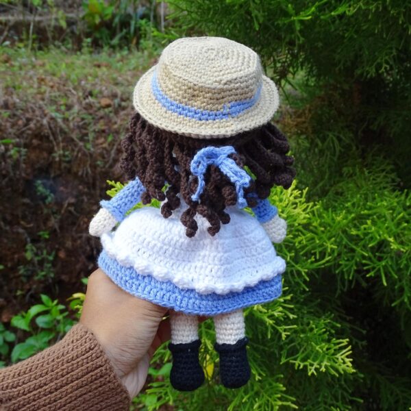 Crochet amigurumi girl doll with hat back view