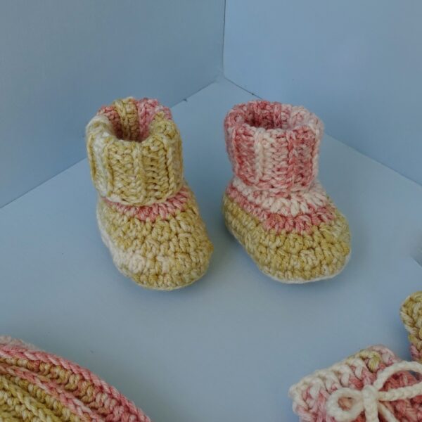 Handmade crochet baby booties in pink and beige combination