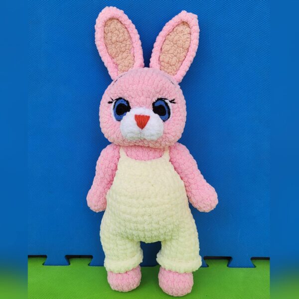 Crochet amigurumi plushie bunny in overall with blue eyes