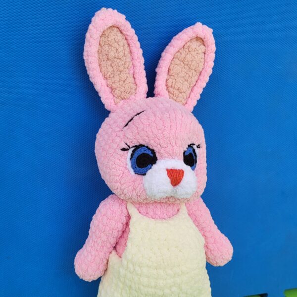 Crochet amigurumi plushie bunny in overall side view