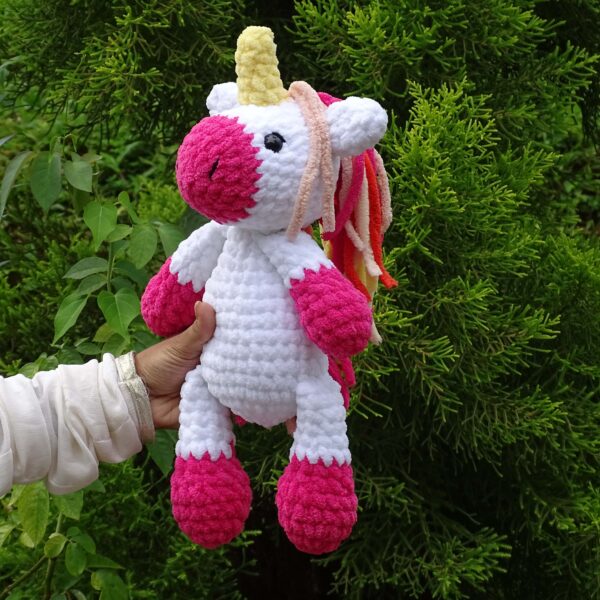 Crochet amigurumi handmade unicorn plushie in pink and white combination front view