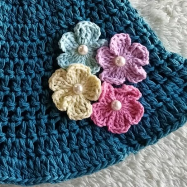 crocheted pastel applique flowers on a hat