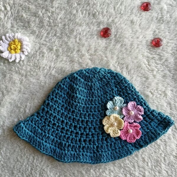 a teal color crocheted bucket hat on a light background