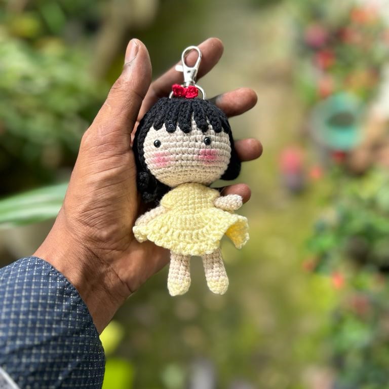 Little doll keychain in yellow dress